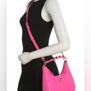BCBG pink crossbody bag with gold pyramid studs .